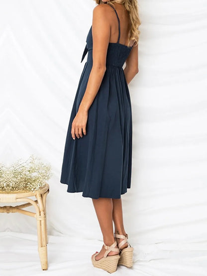 Cutout Smocked Sweetheart Neck Cami Dress with Decorative Button and Opaque Design, showcasing the back view on a model, perfect for summer outings.