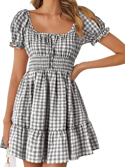 Women's Gingham Puff Sleeve Smocked Dress in classic black and white gingham, featuring puff sleeves and a flirty hem, a stylish choice for summer events.