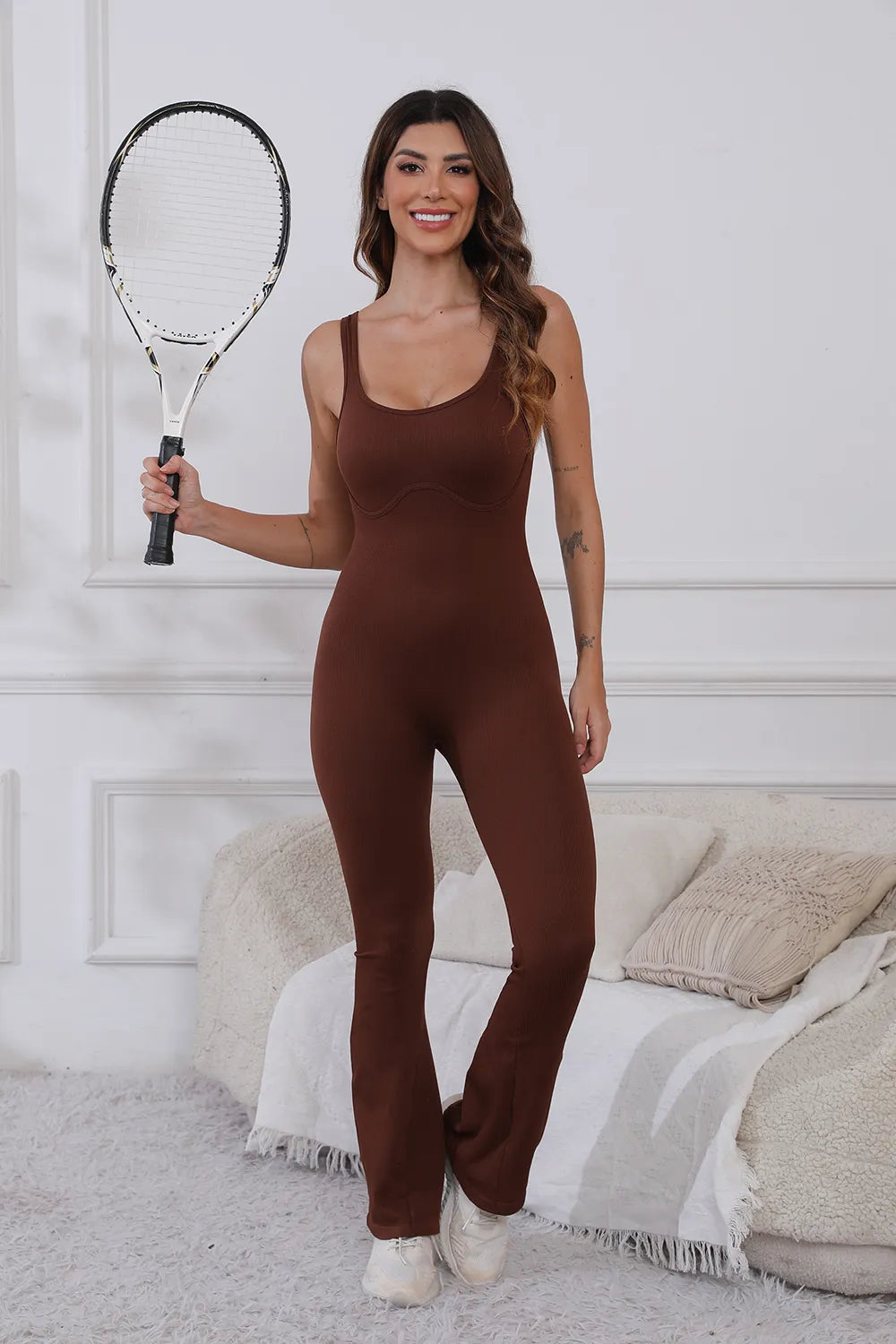 Scoop Neck Wide Strap Active Jumpsuit with Moderate Stretch - Comfortable & Stylish Fitness Wear. Model smiling while showing off a brown jumpsuit, perfect for active lifestyle and comfort.