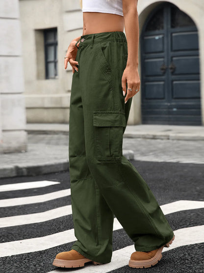 Side view of a trendy woman in green Wide Leg Cargo Jeans, highlighting the cargo pockets and relaxed fit on a city street.