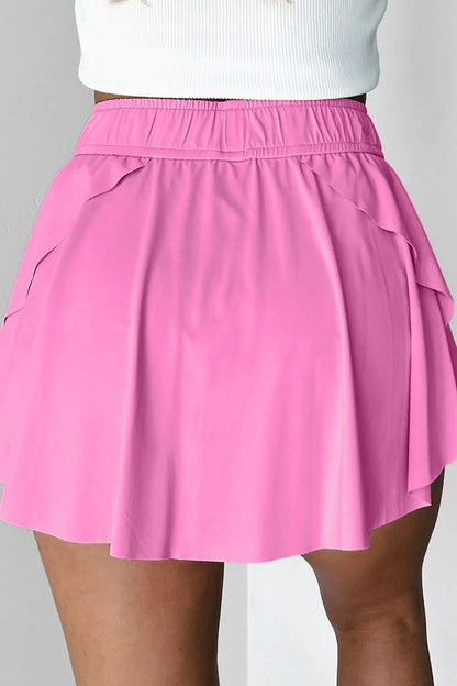 Back view of the Drawstring High Waist Lined Active Skorts in pink, highlighting the gathered waistband and chic layering design.