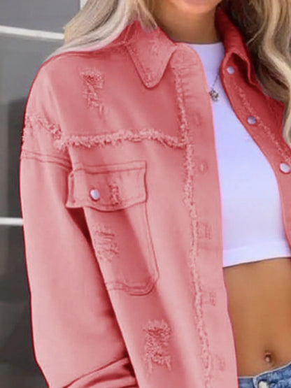 Trendy casual oversized distressed denim jacket with frayed edges and buttoned pockets, showcased in a fashionable pink color.