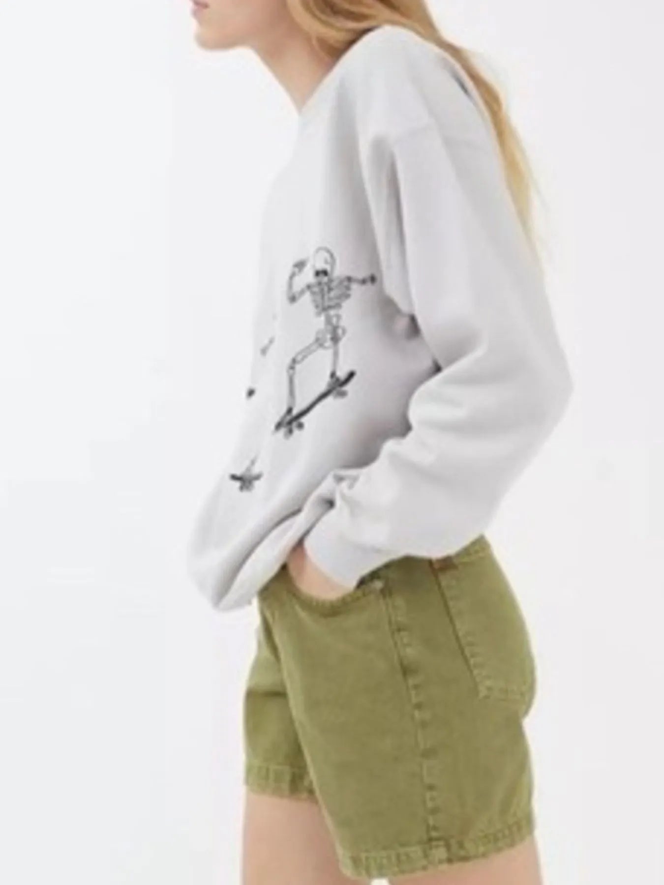 Side view of an Oversized Skeleton Graphic Sweatshirt for Women, highlighting the unique skeleton print and comfortable slightly stretchy material.