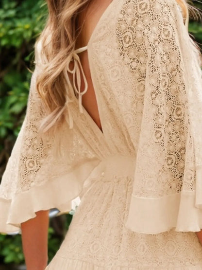 Close-up view of the back of the Semi-Sheer Ruffle Hem Lace Mini Dress With Tie Back - Elegant Smocked Design, highlighting the delicate lace and tie detail.