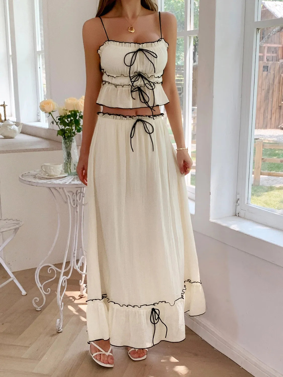 Model showcasing a Two-Piece Frill Square Neck Cami and Ruched Skirt Set in Stretchy Lyocell Blend, featuring a tied frill top and matching ruched skirt, perfect for a stylish summer look.