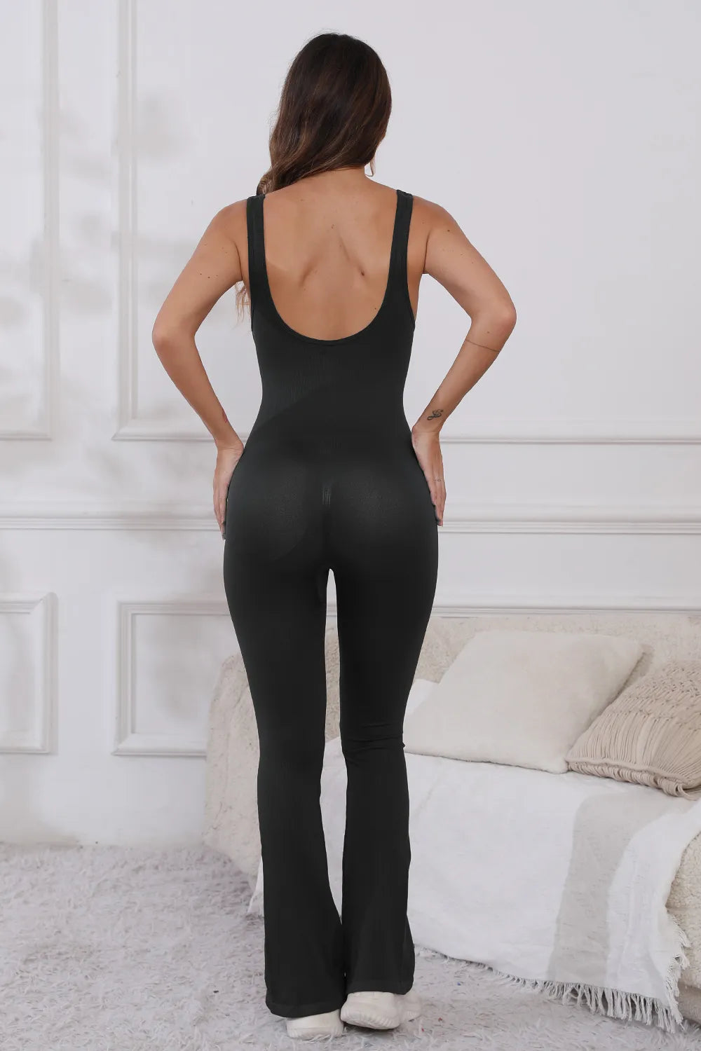Back view of the Scoop Neck Wide Strap Active Jumpsuit with Moderate Stretch in black, highlighting its stylish design and perfect for active lifestyles.