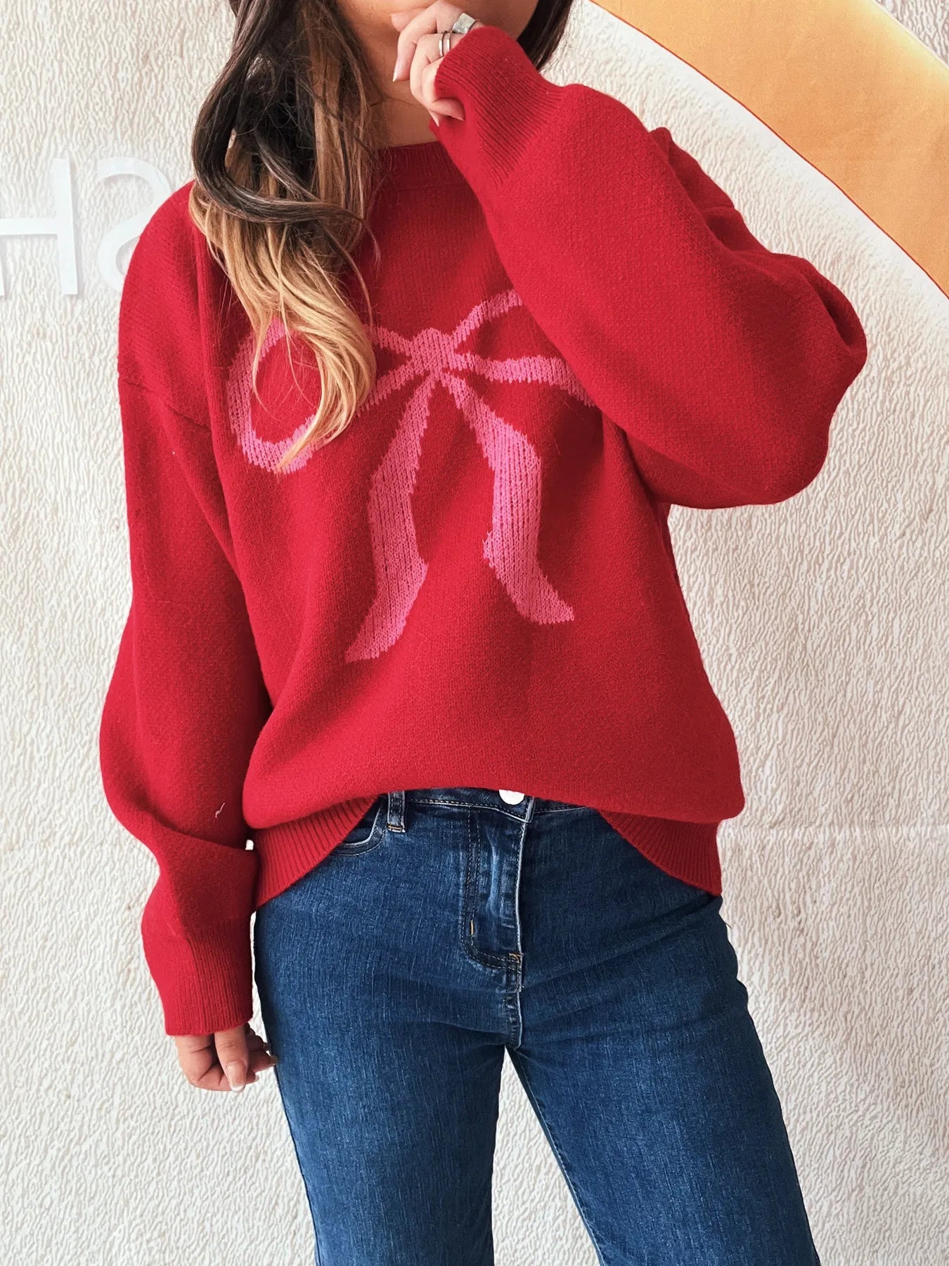 Close-up of the Stylish Bow Pattern Casual Long Sleeve Sweater for Effortless Everyday Wear worn by a model, emphasizing the soft texture and stylish bow design.