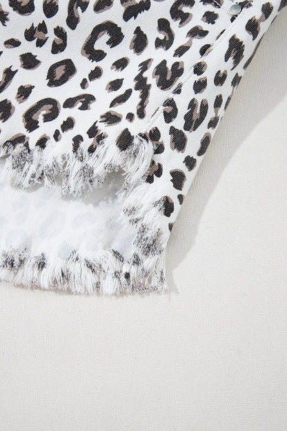 Close-up of Leopard Frayed Hem Denim Shorts - Detail of frayed hem and leopard pattern fabric.