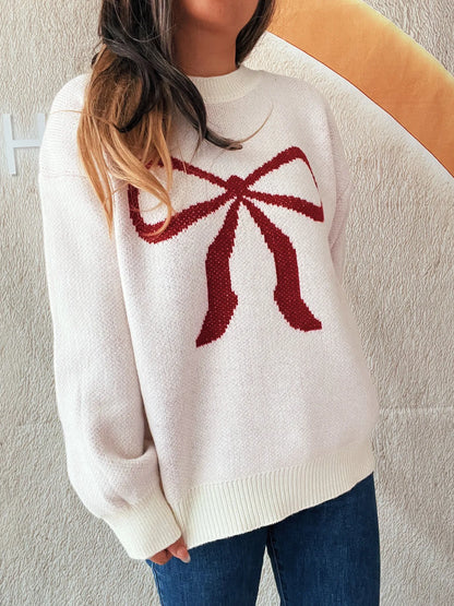 Stylish Bow Pattern Casual Long Sleeve Sweater for Effortless Everyday Wear, emphasizing a unique red bow motif on a soft pink sweater, worn with casual jeans.