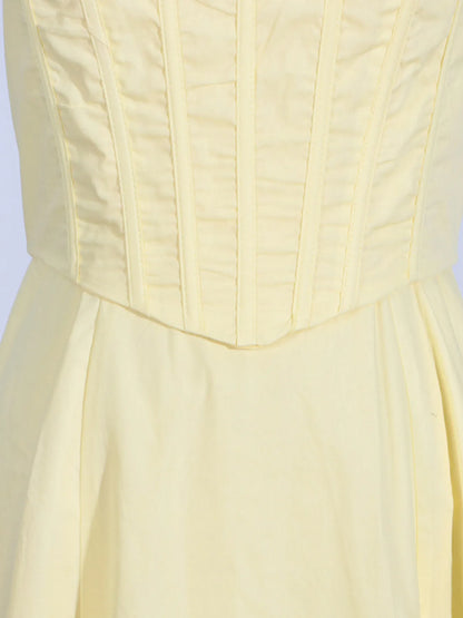 Close-up of the bodice of the Trendy Slit Sleeveless Midi Dress with Zip Back in yellow, displaying the stitching detail of the fitted bodice.