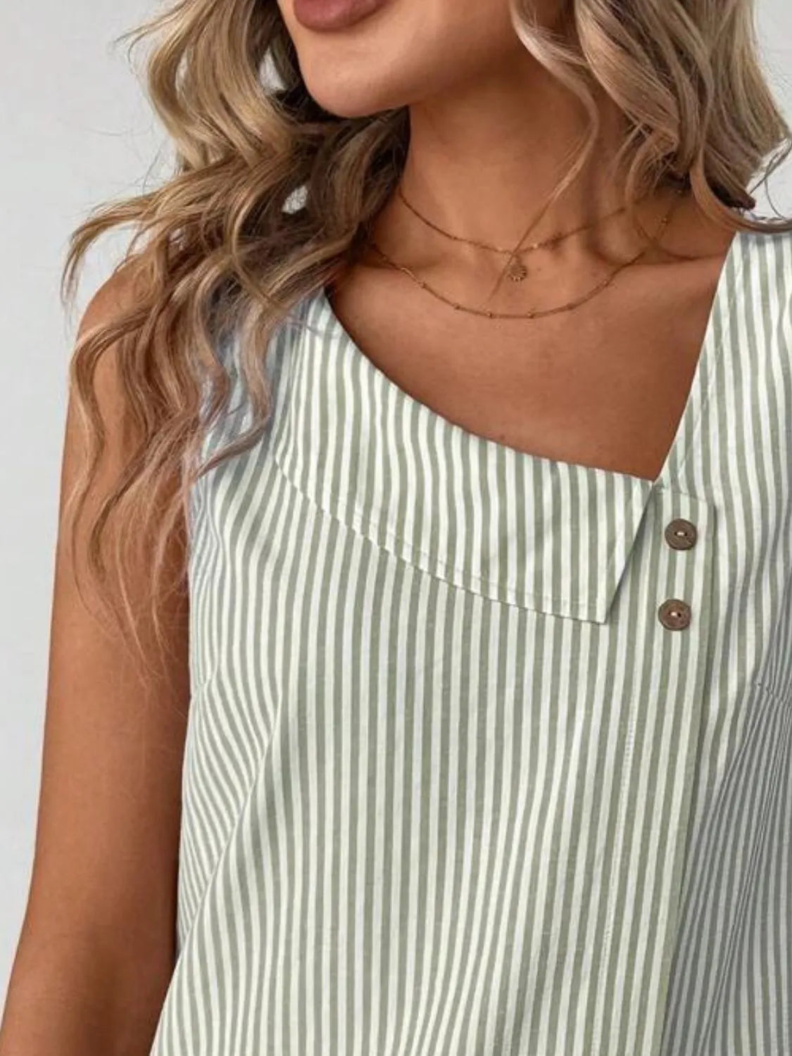 Side view of the Asymmetrical Striped Tank with Decorative Buttons for Women, showcasing its flattering cut and comfortable fit.