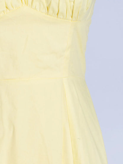 Detailed view of the frill and fabric of the Trendy Slit Sleeveless Midi Dress with Zip Back in yellow, showcasing the soft 100% polyester material.