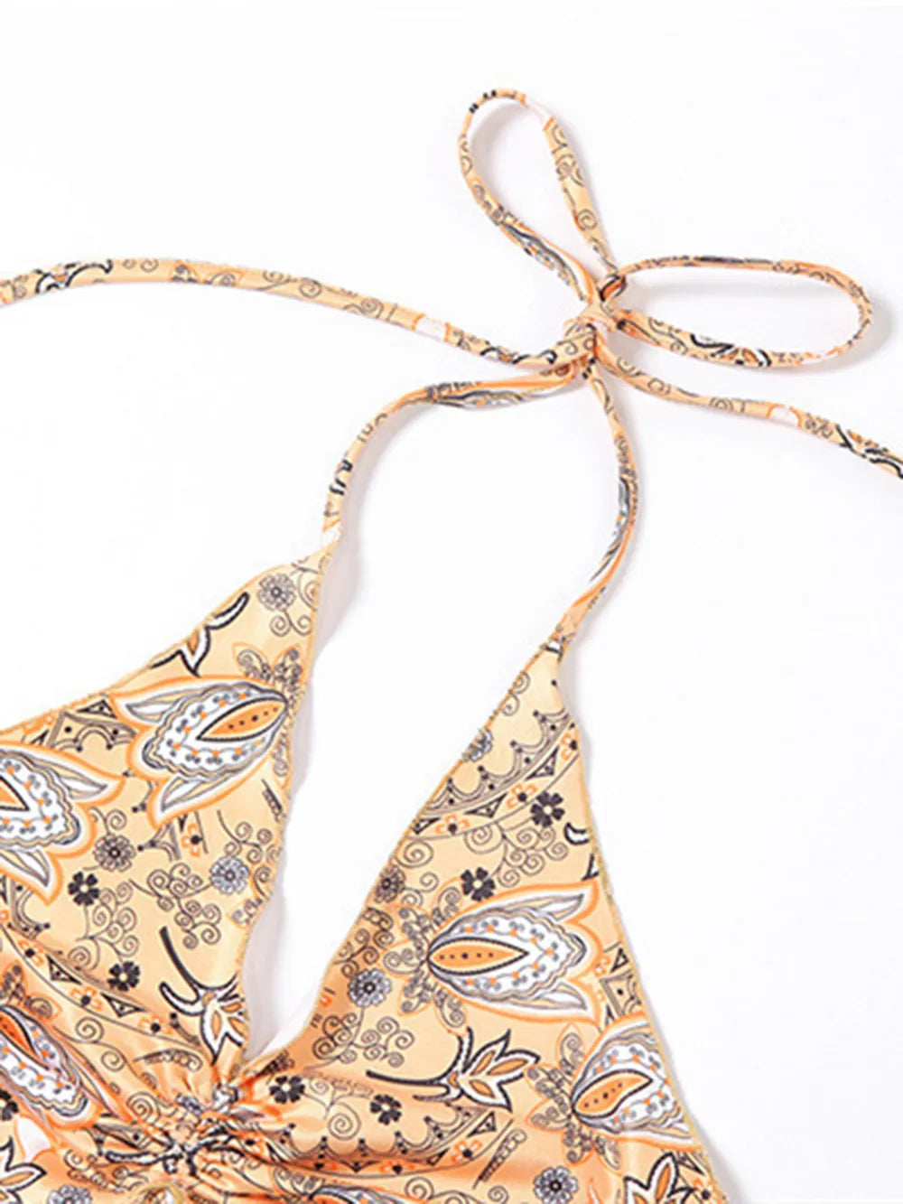 Trendy Printed Halter Neck Cami Top showing fabric pattern with a tied halter neck design, made of stretchy and opaque material, perfect for casual wear.