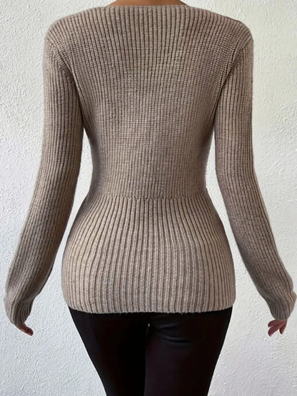 Back view of the Sleek Ribbed V-Neck Knit Top with Twist Front Detail, revealing the fitted ribbed design in stylish beige, ideal for a streamlined silhouette and modern fashion statements.