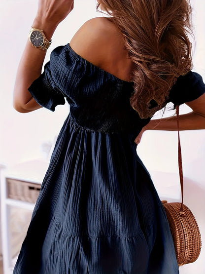 Full Size Ruffled Off-Shoulder Dress with Short Sleeves - Stretchy, Chic & Ruched Design showcased on a model from the back, highlighting the elegant ruffled off-shoulder detail and flowing fabric.