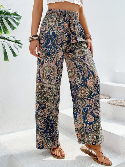 Trendy Printed Wide Leg Pants with Tied Detail displayed on a model in a stylish outfit, featuring a paisley pattern and perfect drape, made of 100% opaque polyester.