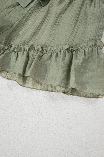 Close-up shot of the ruffle hem of the Textured Tie Waist Ruffle Hem Shorts, showcasing the soft fabric and feminine design.
