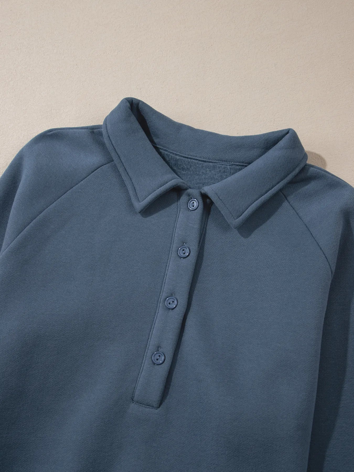 Close-up view of the collar and button details on the Trendsi Collared Sweatshirt & High Waist Pants Two-Piece Active Set - Soft Cotton Blend.
